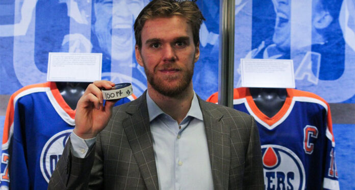 McDavid-100th-point-puck Connor Mcdavid poses with his 100th NHL point game puck