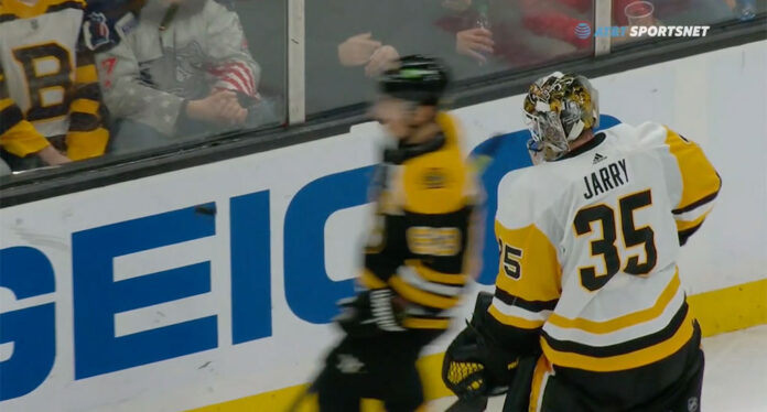 Marchand-trolls-Jarry Brad Marchand prevents Tristan Jarry from giving puck to fan in stands