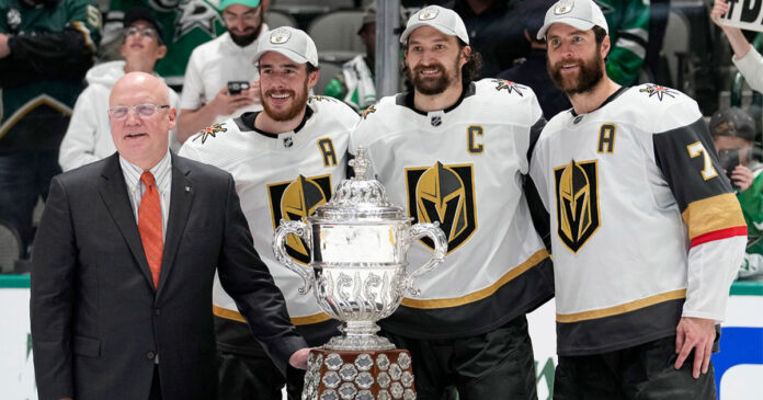 Vegas-Golden-Knights Vegas Golden Knights pose with Billy Daly and the Clarance Campbell Bowl Trophy
