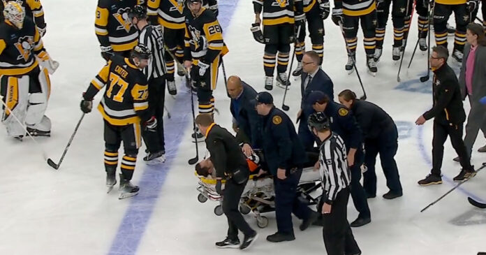 Steve-Kozari-stretchered-off NHL ref Steve Kozari stretchered off the ice