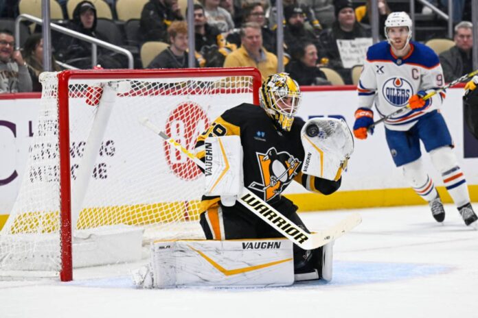 Pittsburgh Penguins goaltender Alex Nedeljkovic (39) makes a glove save during the third period in the NHL game between the Pittsburgh Penguins and the Edmonton Oilers on January 9, 2025, at PPG Paints Arena in Pittsburgh, PA Penguins' Alex Nedeljkovic Makes Insane NHL Goalie History vs Sabres