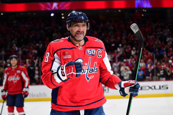 Capitals left wing Alexander Alex Ovechkin (8) celebrates after his 880th career NHL goal during the second period during the Edmonton Oilers versus Washington Capitals National Hockey League game on February 23, 2025 at Capital One Arena in Washington, D.C. Alex Ovechkin Washington Capitals in-game action shot, photographed by Randy Litzinger of Icon Sportswire