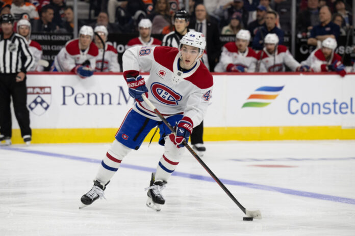 Montreal Canadiens defenseman Lane Hutson (48) looks to pass during the game between the Montreal Canadiens and the Philadelphia Flyers on March 27th, 2025 at the Wells Fargo Center in Philadelphia, PA. Lane Hutson Montreal Canadiens defenseman skates with the puck