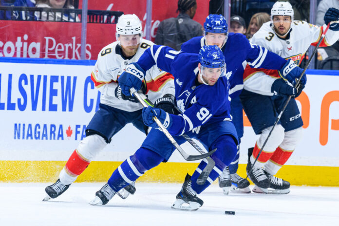 NHL: APR 02 Panthers at Maple Leafs TORONTO, ON - APRIL 02: Toronto Maple Leafs Center John Tavares (91) skates with the puck away from Florida Panthers Center Sam Bennett (9) during the NHL regular season game between the Florida Panthers and the Toronto Maple Leafs on April 2, 2025, at Scotiabank Arena in Toronto, ON, Canada.
