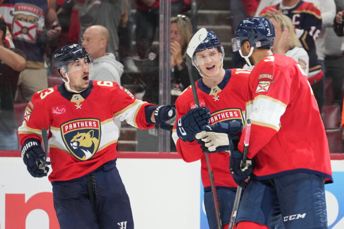 NHL: APR 28 Stanley Cup Playoffs First Round Lightning at Panthers Florida Panthers defenseman Seth Jones celebrates his go-ahead goal with Florida Panthers center Anton Lundell and Florida Panthers center Brad Marchand