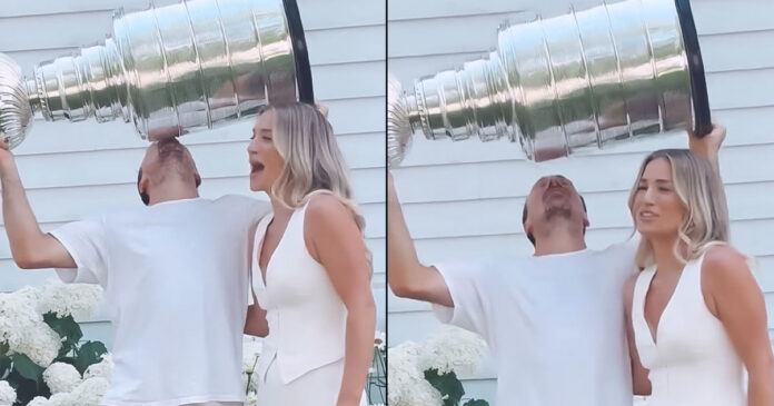Marchand-kisses-cup-over-wife Brad Marchand kisses Stanley Cup while positioned over his wife in humorous celebration
