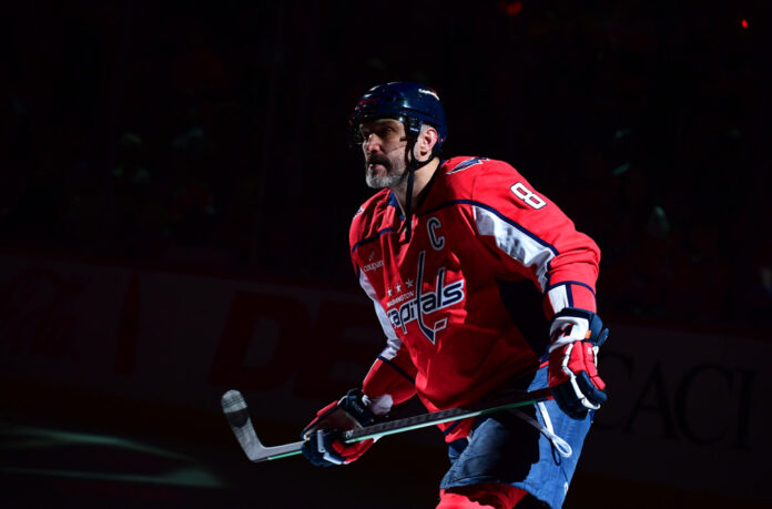 NHL: APR 12 Penguins at Capitals Alex Ovechkin skates through a spotlight during warm-ups before the Capitals vs Penguins game