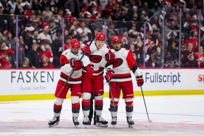 NHL: APR 25 Playoffs First Round Hurricanes at Senators Alexander Nikishin Carolina Hurricanes helped off the ice by Shayne Gostisbehere and Seth Jarvis Game 4 2026 Stanley Cup Playoffs Senators concussion