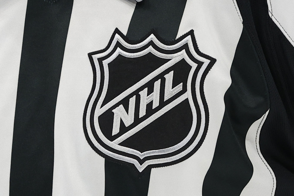 NHL logo on an official's jersey during a regular season game