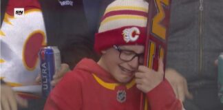 Young Flames fan Kade Heisler tears up after receiving Dustin Wolf goalie stick