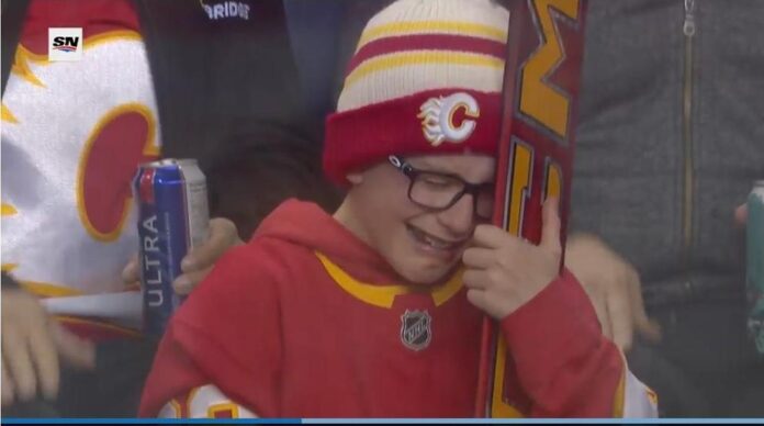 dustin_wolf_fan_kade_heisler_stick_gift Young Flames fan Kade Heisler tears up after receiving Dustin Wolf goalie stick