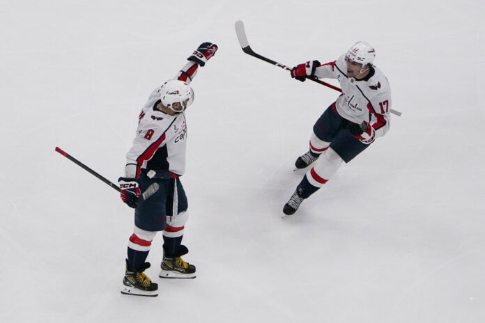 NHL: MAR 26 Capitals at Mammoth Dylan Strome and Alex Ovechkin celebrate a goal during a Capitals game at Delta Center