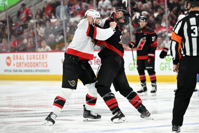NHL: APR 18 Stanley Cup Playoffs First Round Senators at Hurricanes Brady Tkachuk and Jordan Staal fight after the opening faceoff of Game 1
