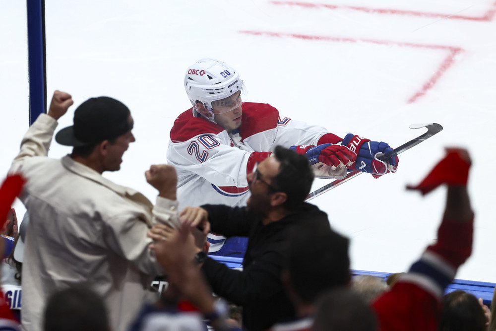 Juraj Slafkovsky celebrates at the glass after his overtime goal in Game 1 of the 2026 first round