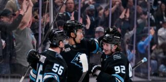 Utah Mammoth players celebrate after clinching a playoff berth at Delta Center