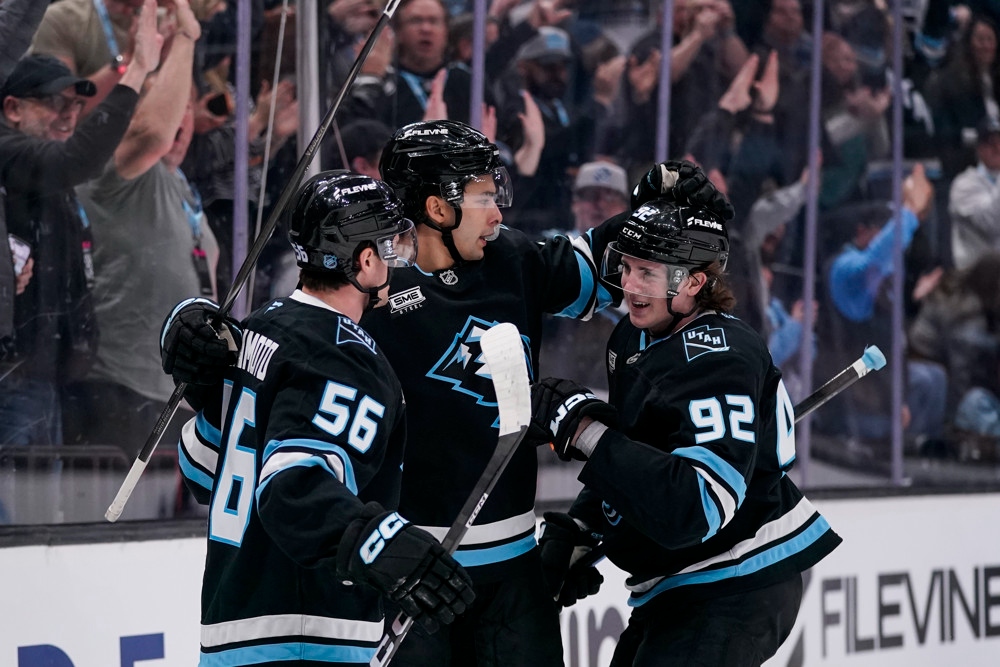 Utah Mammoth players celebrate after clinching the first playoff berth in club history at Delta Center