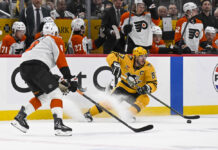 Pittsburgh Penguins Sidney Crosby skates with the puck against Philadelphia Flyers defenseman Cam York during Game 5 of the 2026 Stanley Cup Playoffs at PPG Paints Arena