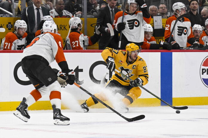 Cam York and Sidney Crosby Game 5 Flyers Penguins 2026 Pittsburgh Penguins Sidney Crosby skates with the puck against Philadelphia Flyers defenseman Cam York during Game 5 of the 2026 Stanley Cup Playoffs at PPG Paints Arena