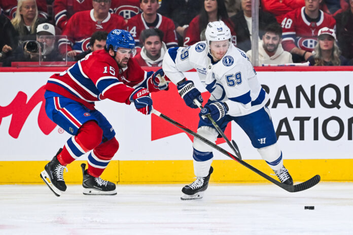 Alex Newhook Canadiens vs Lightning Game 6 2026 Montreal Canadiens center Alex Newhook defends the puck against Tampa Bay Lightning center Jake Guentzel during the 2026 Stanley Cup Playoffs First Round at Bell Centre