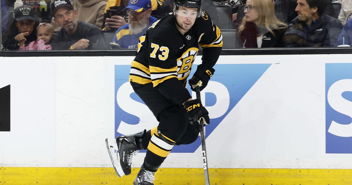 Charlie McAvoy carries the puck for the Boston Bruins