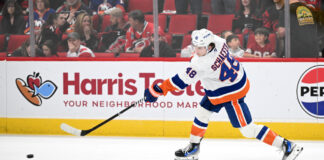 NHL Top 20 Defensemen Revealed: Schaefer Debuts at No. 7 New York Islanders defenseman in white road jersey during game action