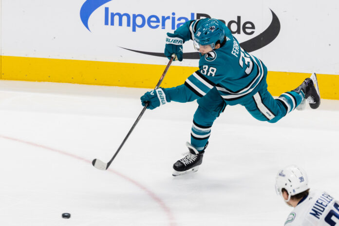 NHL: APR 11 Canucks at Sharks Mario Ferraro San Jose Sharks defenseman shoots puck against Vancouver Canucks