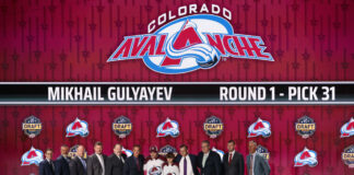 Gulyayev Signs 2-Year KHL Extension, Delays Avs Debut to 2028 Colorado Avalanche draft pick Mikhail Gulyayev poses with team officials after being selected 31st overall at the 2023 NHL Draft in Nashville