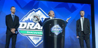 Henrik Sedin and Daniel Sedin on stage with NHL Commissioner Gary Bettman at the 2019 NHL Draft in Vancouver