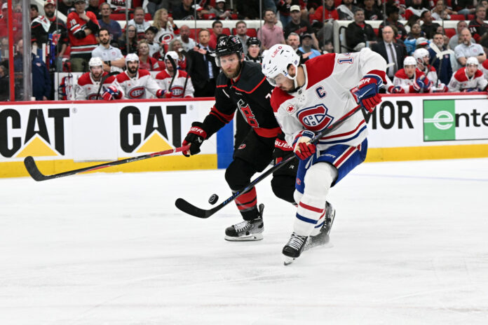 NHL: MAY 21 Eastern Conference Final Canadiens at Hurricanes Jaccob Slavin Carolina Hurricanes turns puck over to Nick Suzuki Montreal Canadiens Game 1 Eastern Conference Final May 21 2026 Lenovo Center