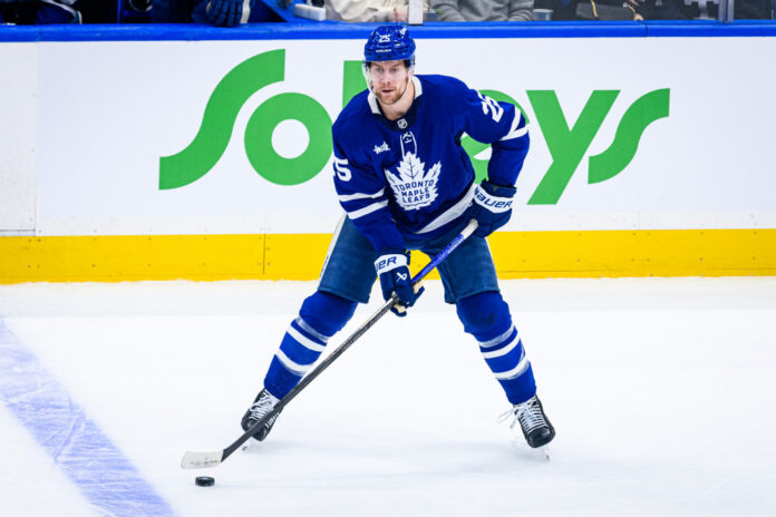 Brandon Carlo Blues trade Toronto Maple Leafs defenseman Brandon Carlo skates with the puck before being traded to the St. Louis Blues