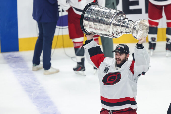 NHL: JUN 14 Stanley Cup Final Hurricanes at Golden Knights Carolina Hurricanes goaltender Brandon Bussi hoists the Stanley Cup after a Game 6 shutout in the 2026 Final