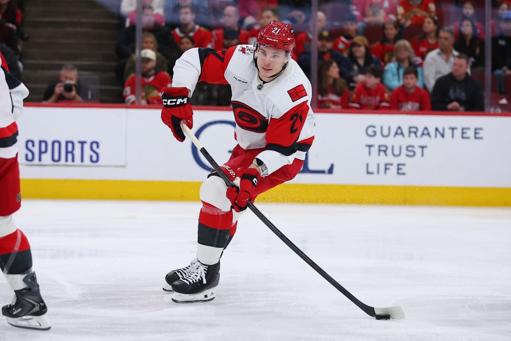 Alexander Nikishin Carolina Hurricanes defenseman controls the puck