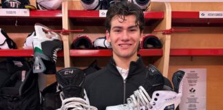 World Junior Summer Showcase: Carels’ White Skates Turn Heads Carson Carels holds his white skates at the 2026 World Junior Summer Showcase in Windsor