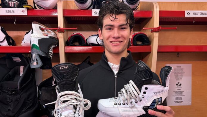 Carson Carels white skates World Junior Summer Showcase 2026 Carson Carels holds his white skates at the 2026 World Junior Summer Showcase in Windsor