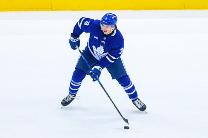 NHL: DEC 16 Blackhawks at Maple Leafs Henry Thrun Maple Leafs defenseman skates with the puck, signs with Winnipeg Jets