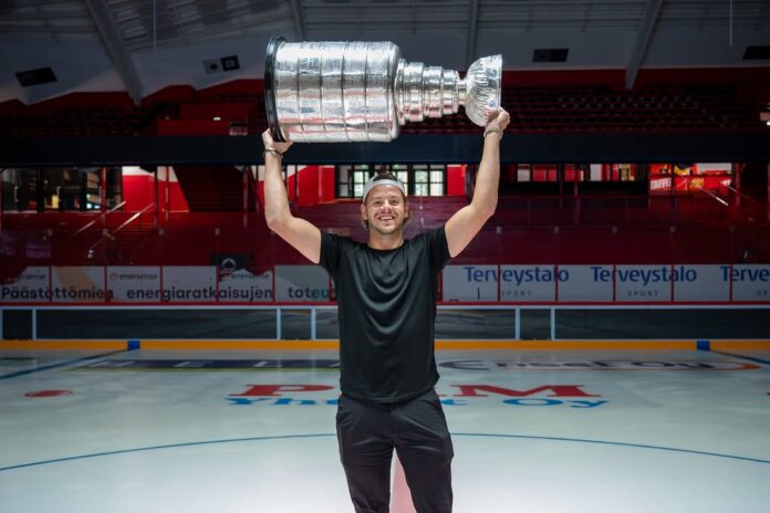 Jesperi Kotkaniemi Stanley Cup Pori Jesperi Kotkaniemi lifts the Stanley Cup at center ice in Pori Finland Enersense Areena Carolina Hurricanes 2026 champion