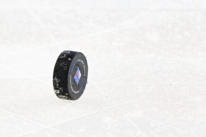 NHL official puck generic Official NHL puck standing on the ice