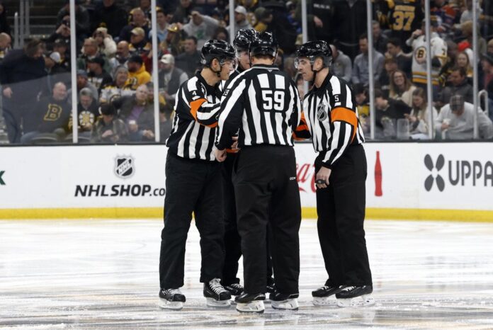 NHL officials referees generic NHL officials gather on the ice during a game