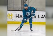 Will Smith skates with the puck at San Jose Sharks practice ahead of his contract extension talks