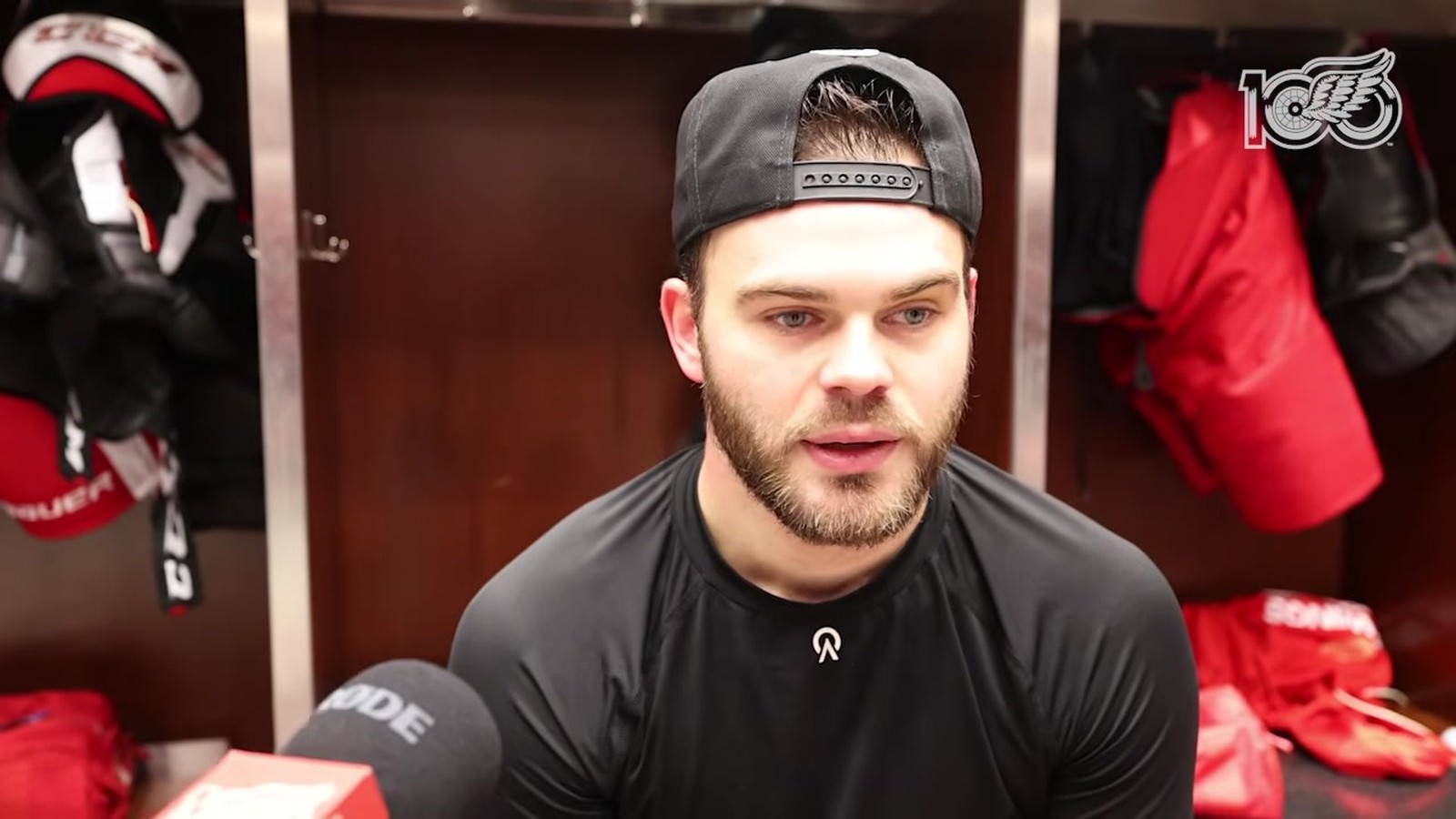 Alex DeBrincat speaks in the Detroit Red Wings dressing room