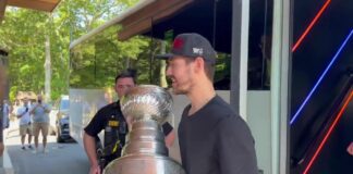 Brandon Bussi Stanley Cup Day: Long Island Lined Up at Dawn Hurricanes goalie Brandon Bussi carries the Stanley Cup off the bus at The Rinx in Hauppauge on Long Island