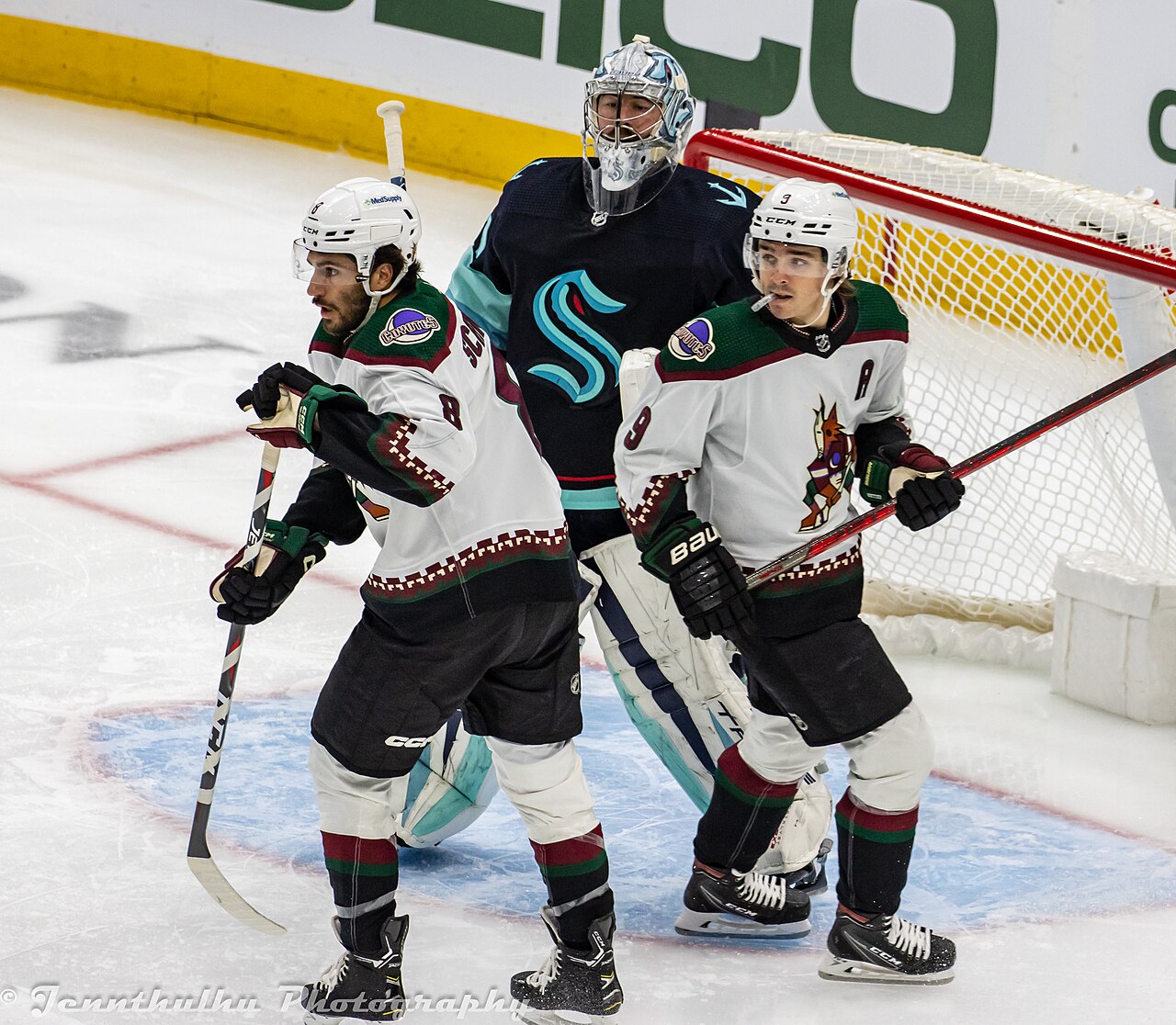 Clayton Keller and Nick Schmaltz screen Seattle goaltender Philipp Grubauer during an April 2023 game