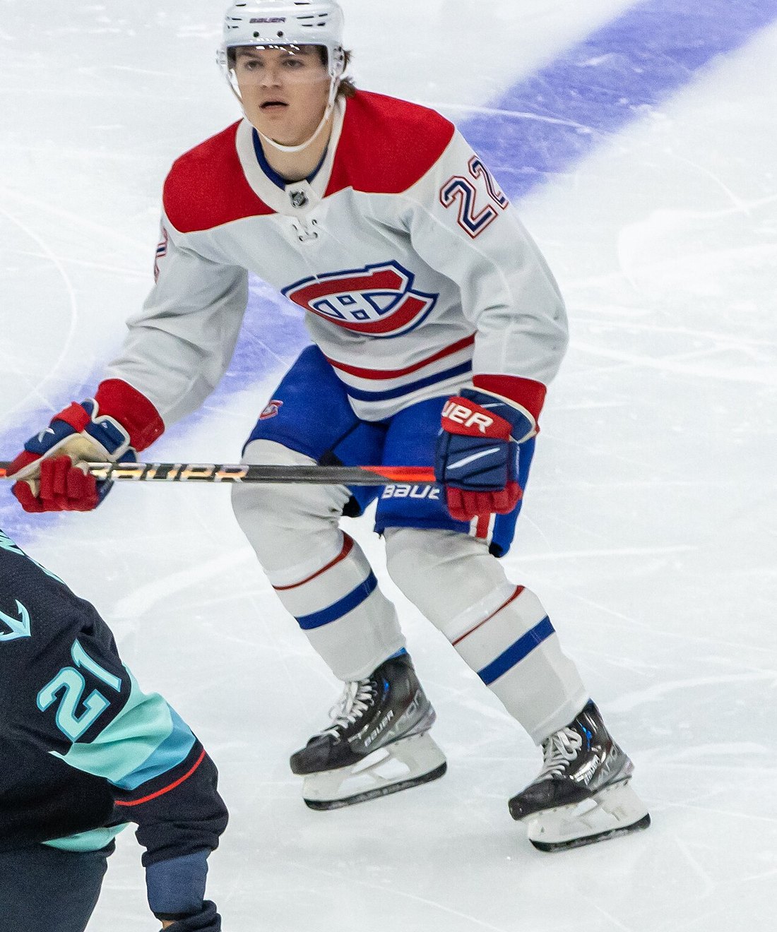Cole Caufield in a white Montreal Canadiens road jersey wearing number 22 against the Seattle Kraken