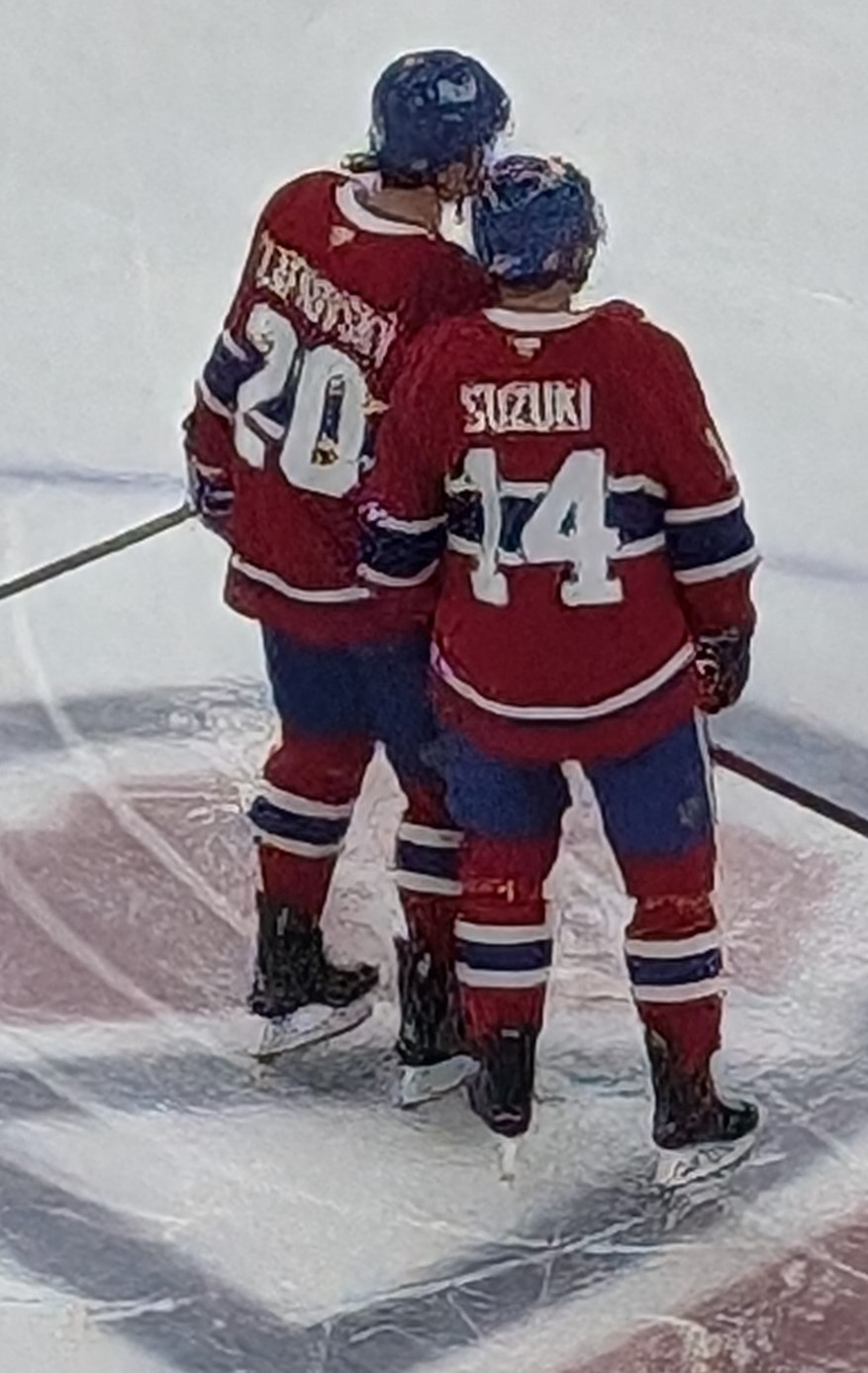 Juraj Slafkovsky and Nick Suzuki in Montreal Canadiens sweaters during pregame warmups