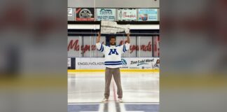 K’Andre Miller Stanley Cup Day: Minnetonka Jersey, Home Rink Carolina Hurricanes defenseman K'Andre Miller hoists the Stanley Cup at center ice in a Minnetonka High School jersey during his 2026 Stanley Cup day in Minnesota
