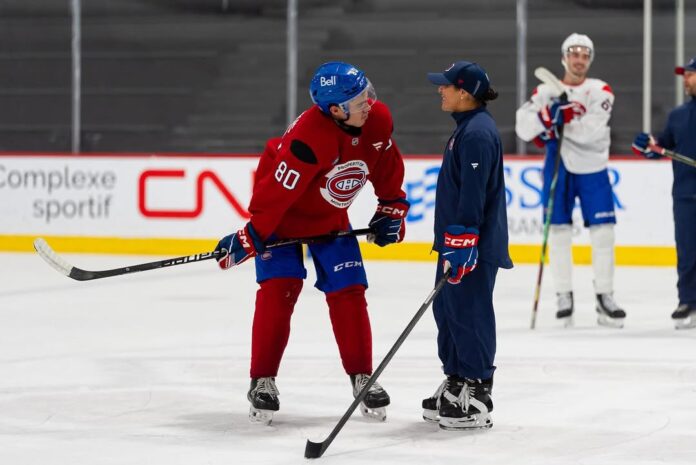 Olivia Cook Canadiens development camp Olivia Cook coaching a Montreal Canadiens prospect on the ice at development camp in Brossard