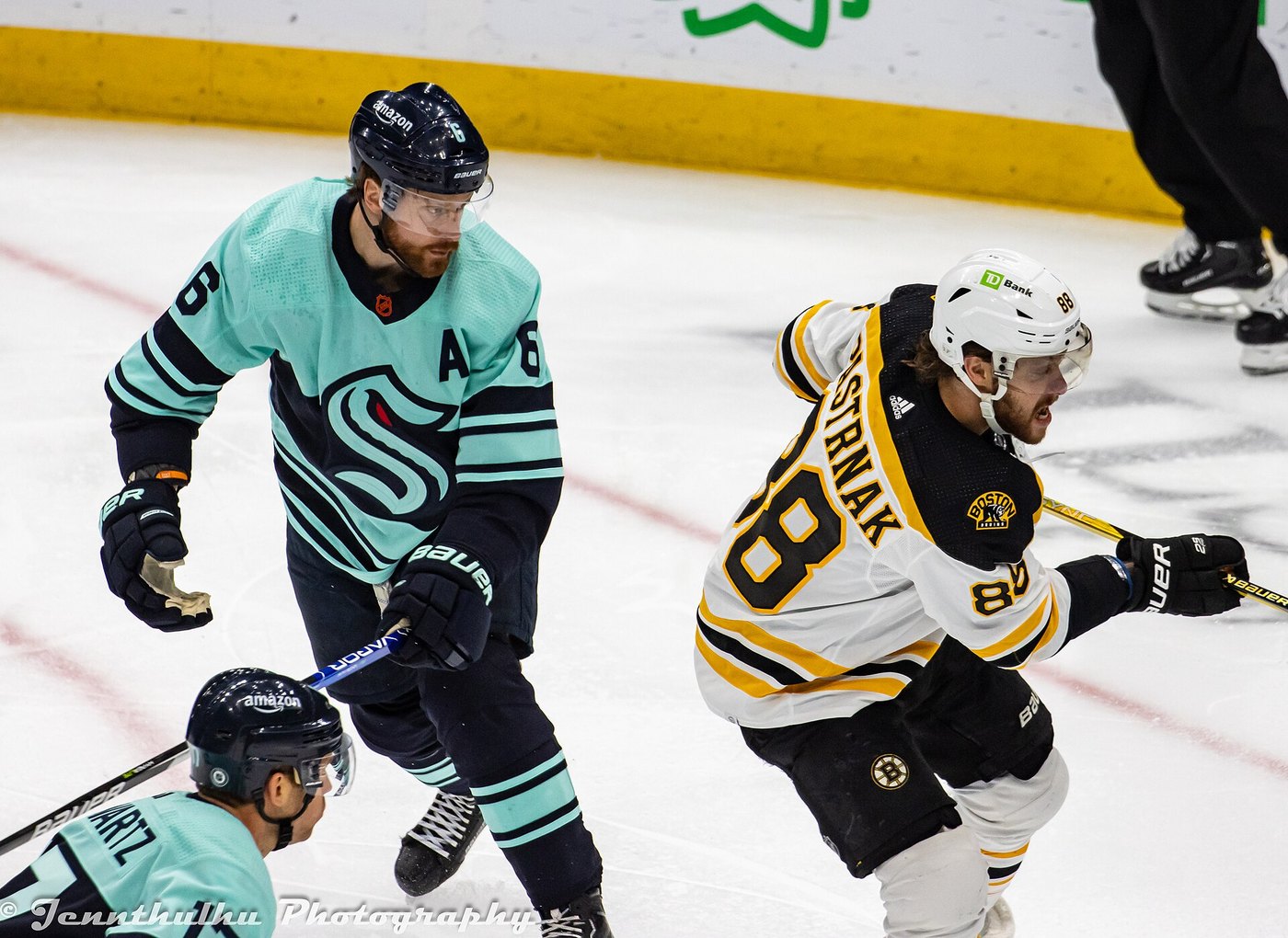 David Pastrnak skates past Adam Larsson during a Bruins game at Seattle in February 2023