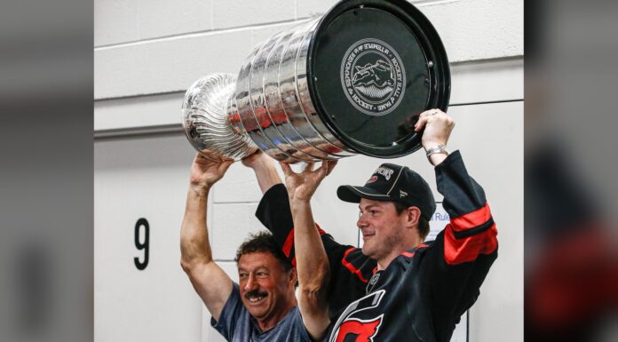 Stanley Cup Day: Eric Robinson Hands It to Guy Gaudreau Eric Robinson and Guy Gaudreau raise the Stanley Cup together at Hollydell Ice Arena in Sewell, New Jersey