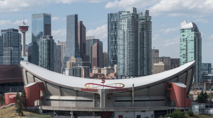 Flames Saddledome Patch: Every Jersey Gets 1983 and 2027 Scotiabank Saddledome exterior with the Calgary skyline behind it as the Flames begin their Dome farewell season