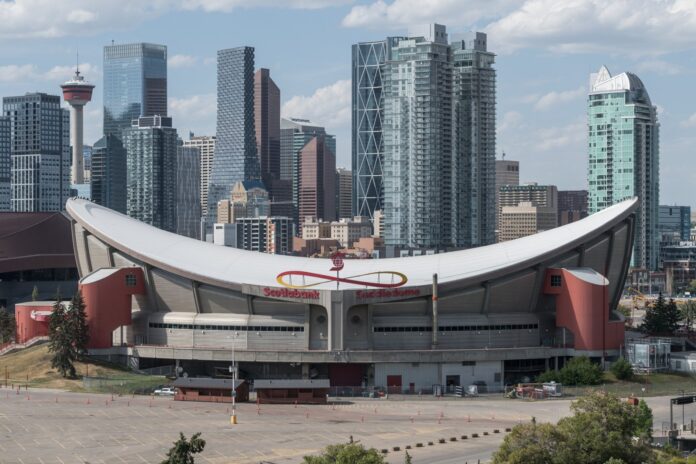 Scotiabank Saddledome farewell season patch 2026-27 Scotiabank Saddledome exterior with the Calgary skyline behind it as the Flames begin their Dome farewell season